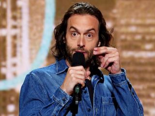 Chris D'Elia Holding A Cell Phone