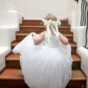 Little girl climbing stairs dressed in white