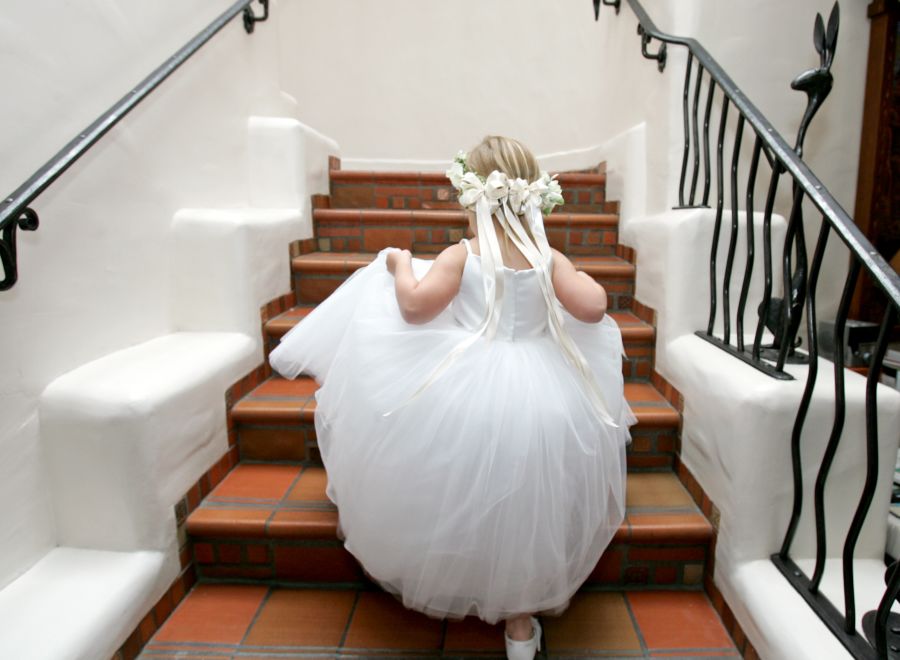 Little girl climbing stairs dressed in white