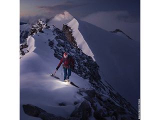 A Man Skiing Down A Mountain